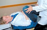 A patient having her hip Passively flexed.